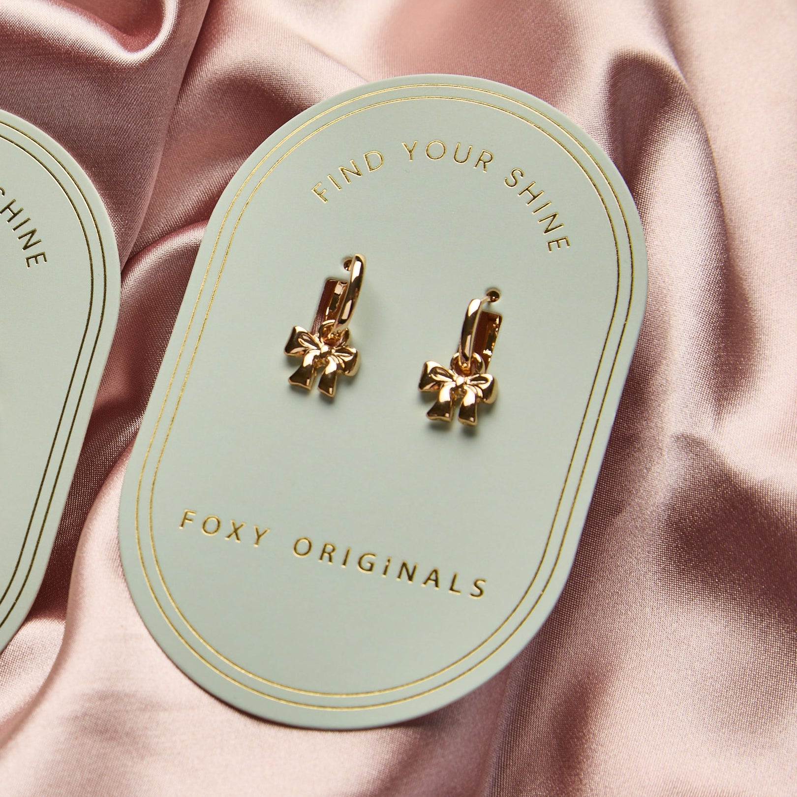 Bow Huggie Hoop Earrings in Gold